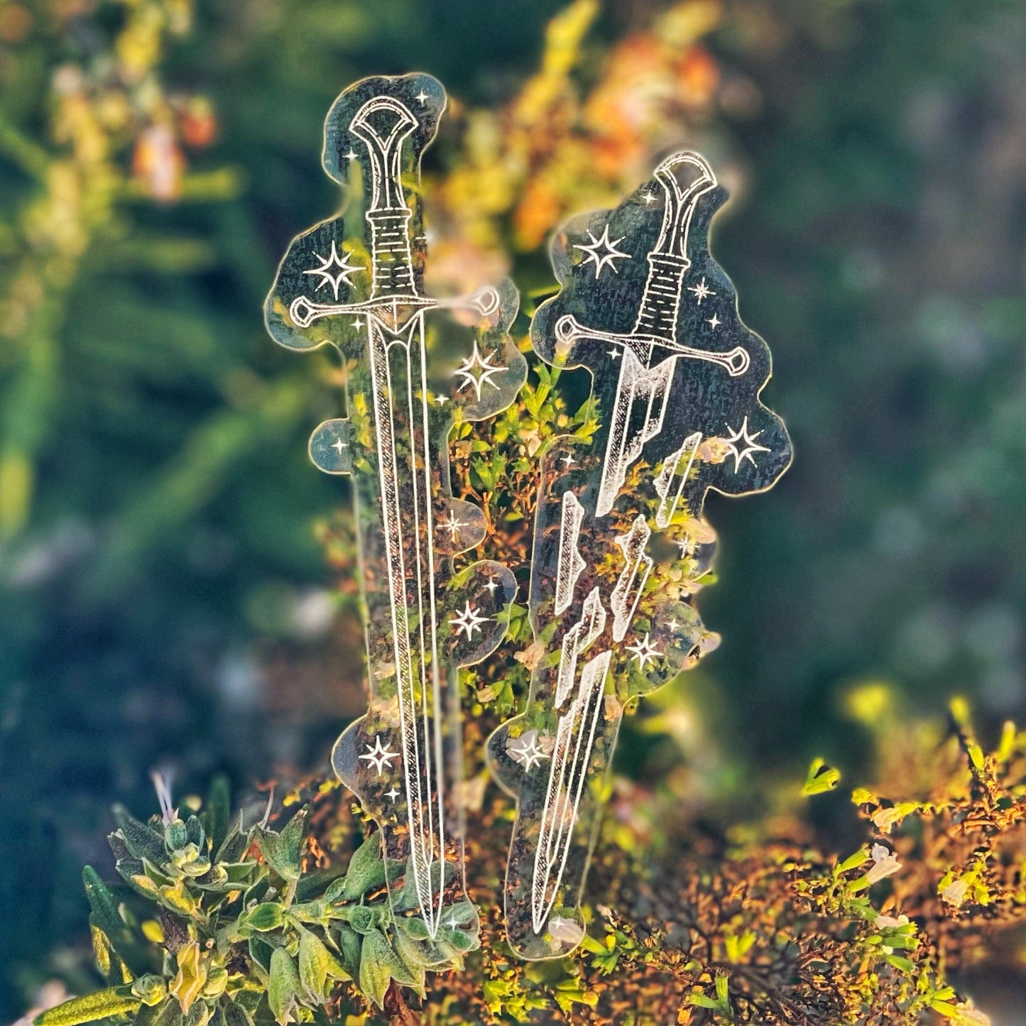 a photo of a sticker depicting two legendary swords from Lord of the Rings