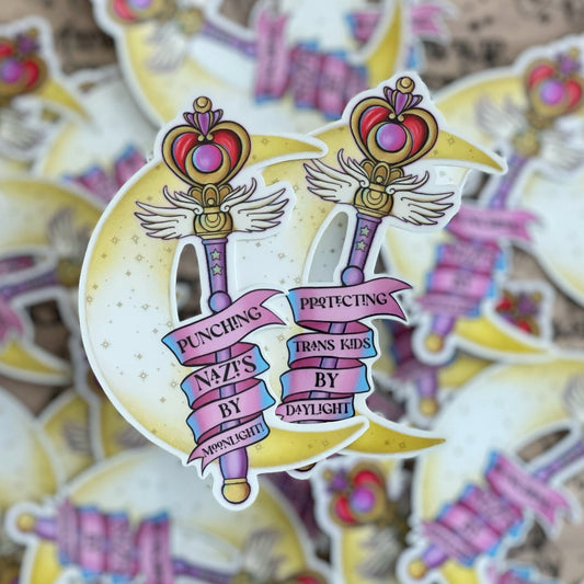 Anti Fascism sticker showing two stickers for protecting trans kids by daylight and punching nazi's by moonlight